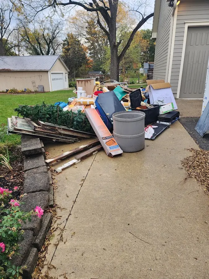 Dumpster being loaded with debris for 12 Yard Dumpster Rental in Newark